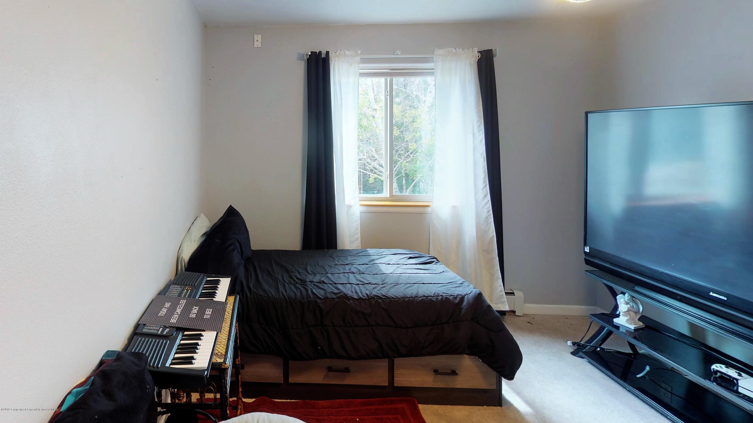 1293 Fir Avenue Rifle, CO 81650 - Photo 3 of 49 a bedroom with a bed and a window
