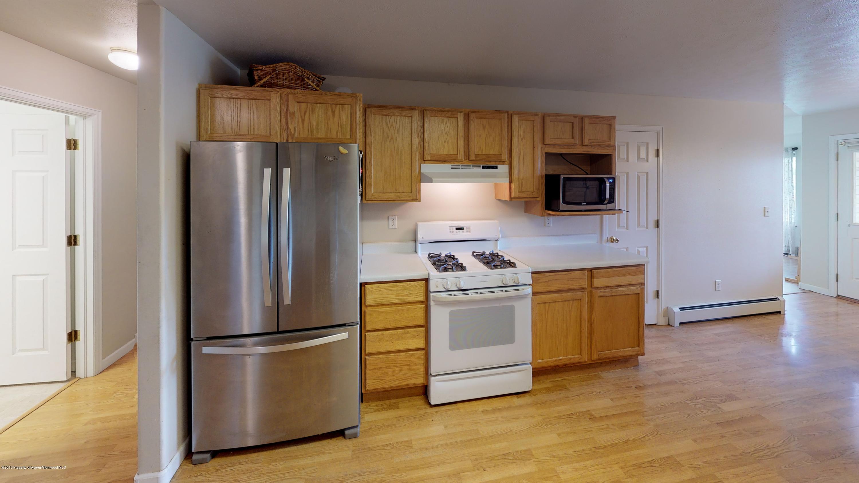 1293 Fir Avenue Rifle, CO 81650 - Photo 36 of 49 a kitchen with stainless steel appliances a refrigerator stove and microwave