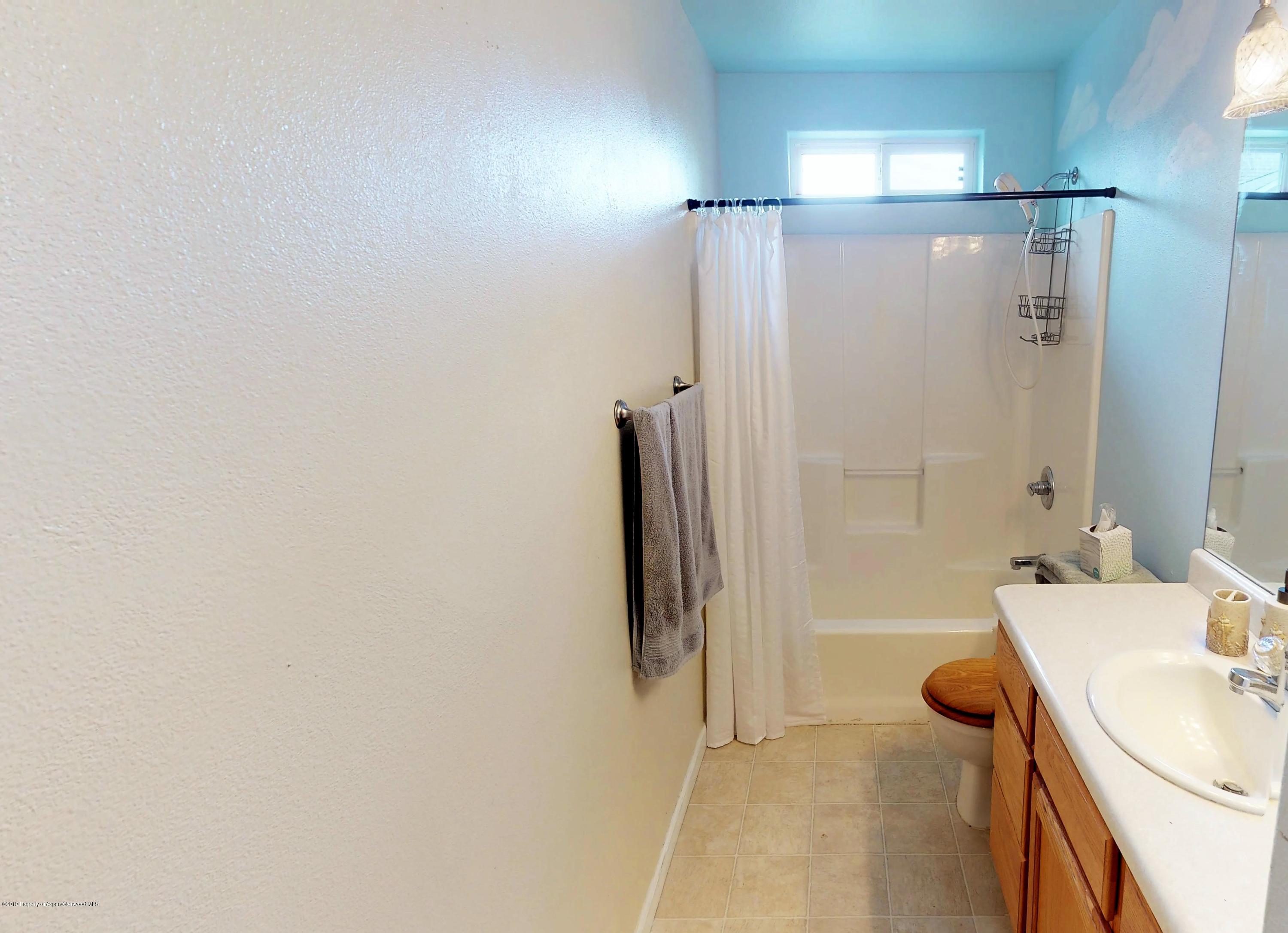 1293 Fir Avenue Rifle, CO 81650 - Photo 5 of 49 a bathroom with a sink and a mirror