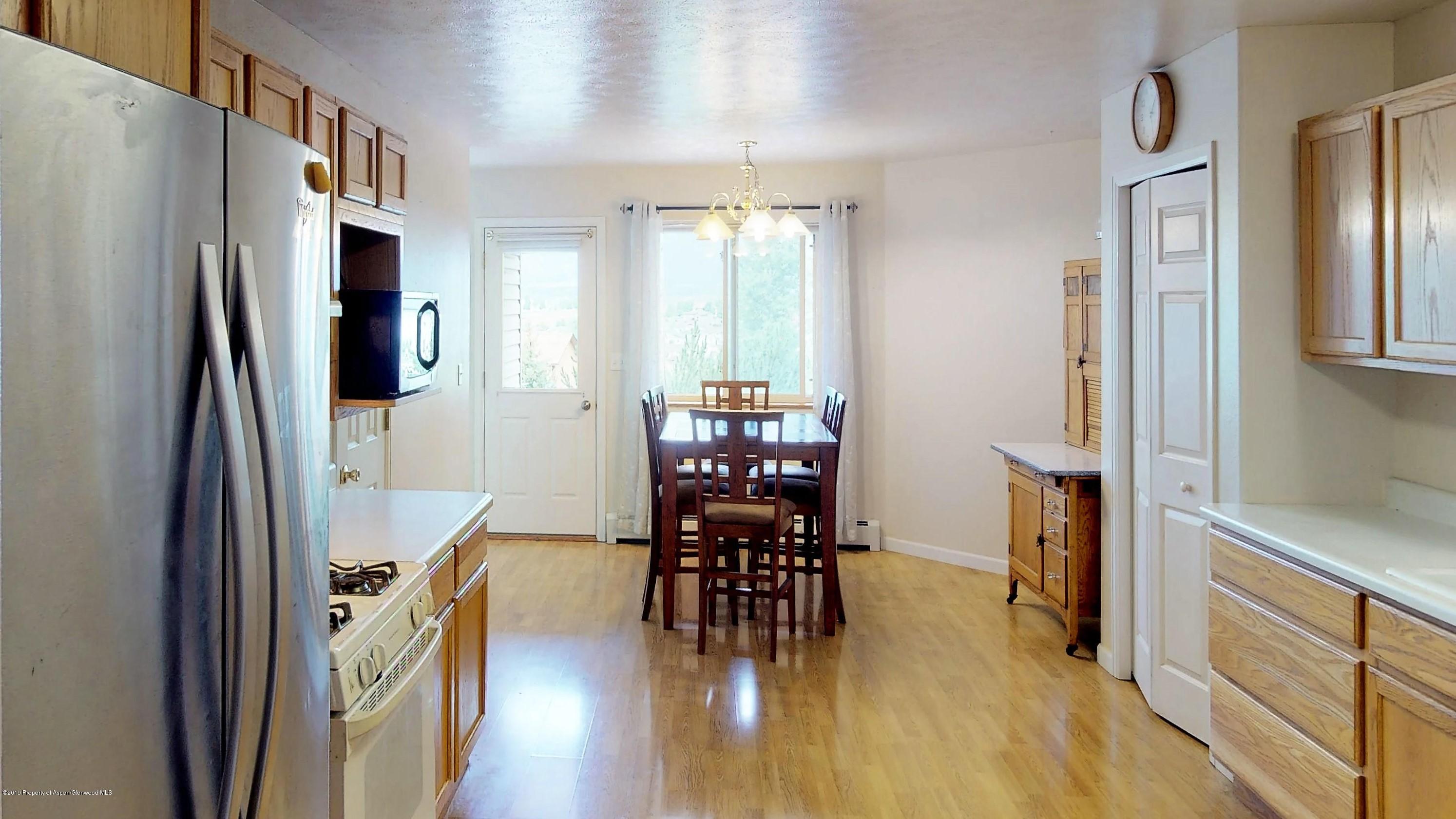 1293 Fir Avenue Rifle, CO 81650 - Photo 9 of 49 a dining room with furniture entryway and wooden floor