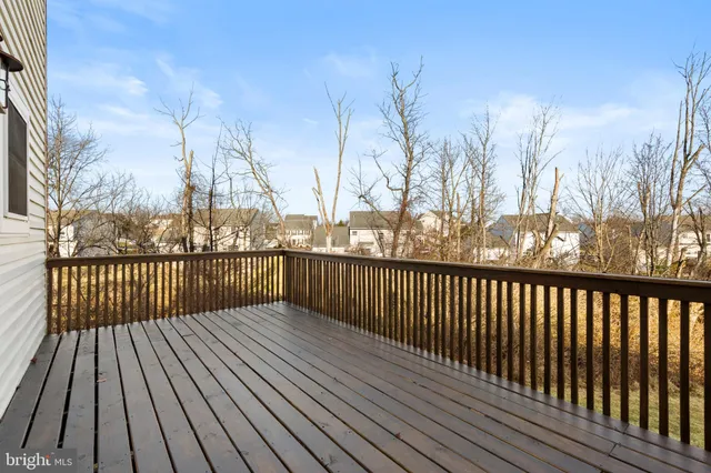a view of balcony with wooden floor and fence