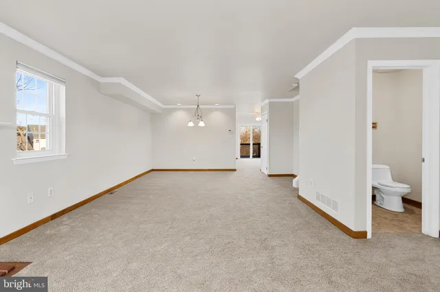 a view of a big room with closet and windows