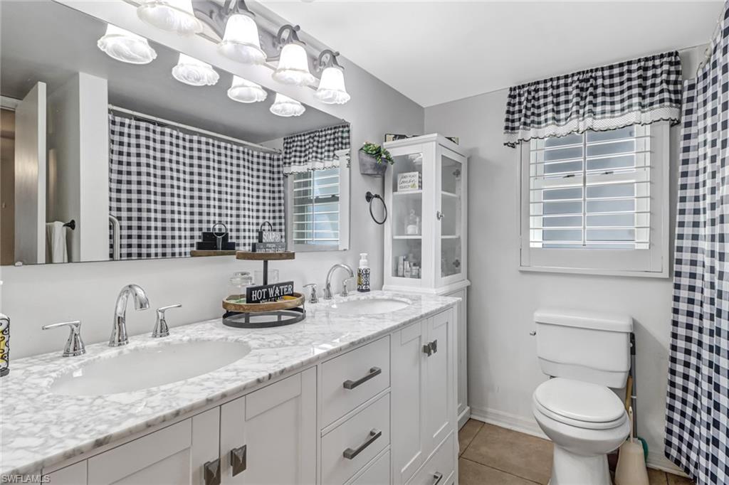 160 4th Street Naples, FL 34113 - Photo 19 of 34 a bathroom with a granite countertop sink vanity mirror and toilet