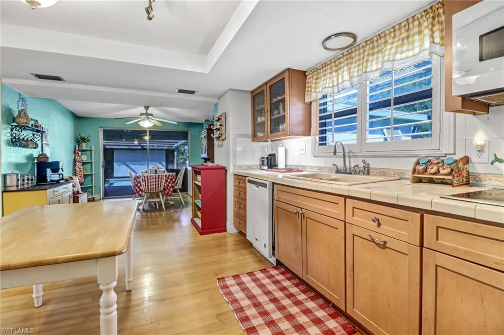 160 4th Street Naples, FL 34113 - Photo 10 of 34 a open kitchen with stainless steel appliances granite countertop a sink and cabinets