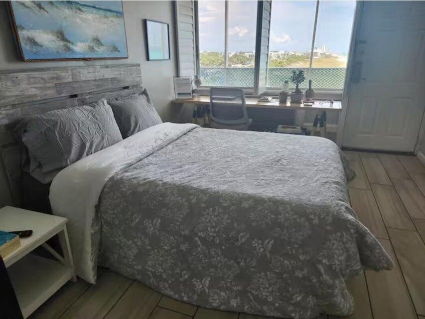 14401 Front Beach Road, Unit 426 Panama City Beach, FL 32413 - Photo 12 of 21 a large white bed sitting in a room next to a window
