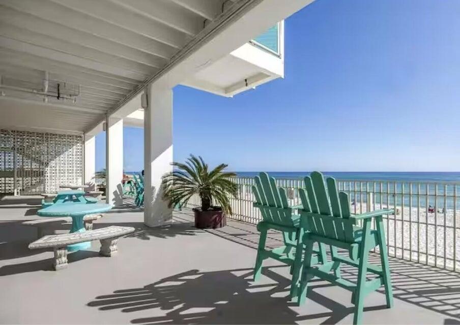 14401 Front Beach Road, Unit 426 Panama City Beach, FL 32413 - Photo 7 of 21 a building with glass top table and chairs