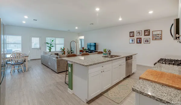 a kitchen with sink stove and cabinets