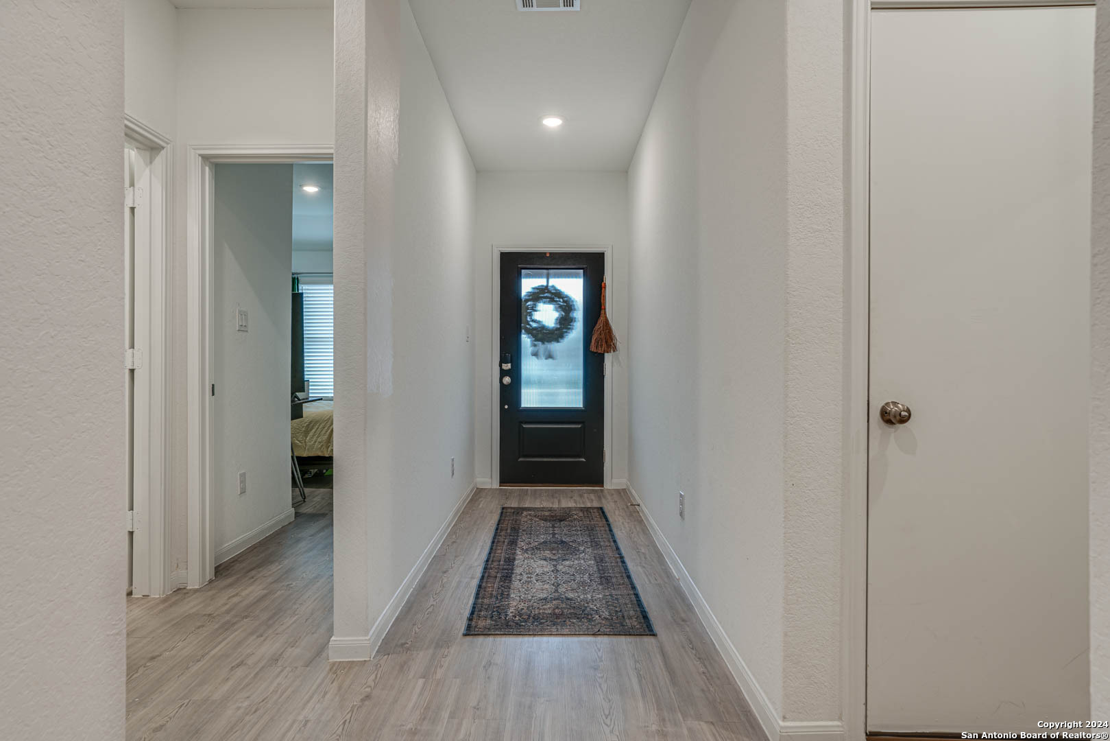 14606 Somerset Mill San Antonio, TX 78254 - Photo 5 of 19 a view of a hallway with wooden floor and staircase