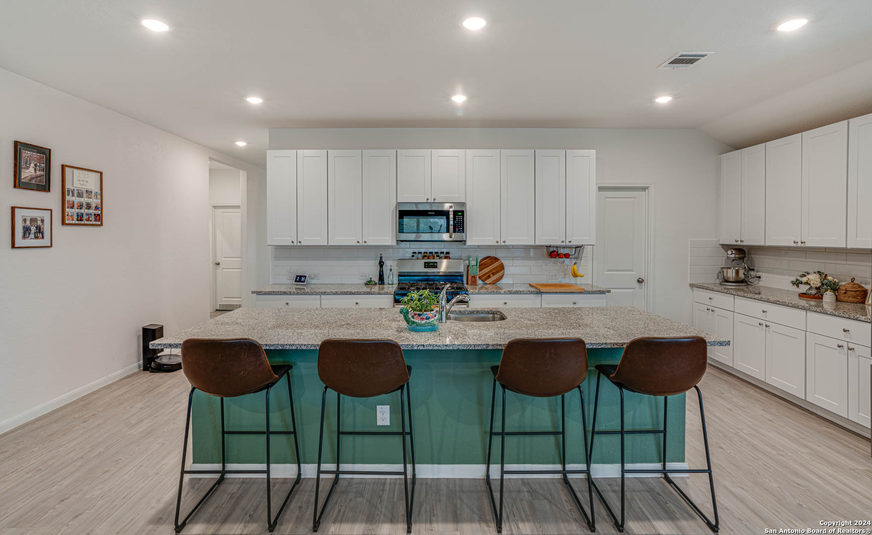 14606 Somerset Mill San Antonio, TX 78254 - Photo 8 of 19 a kitchen with stainless steel appliances granite countertop a stove a sink a stove a dining table and chairs