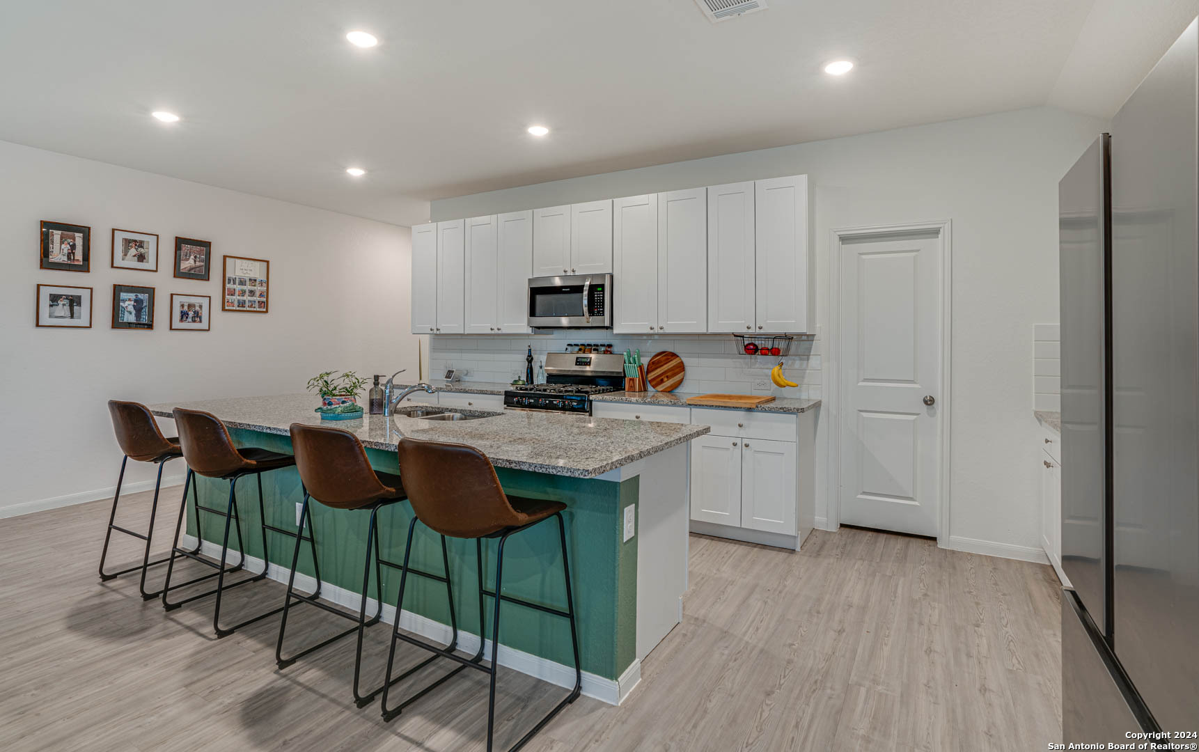14606 Somerset Mill San Antonio, TX 78254 - Photo 10 of 19 a kitchen with granite countertop a sink cabinets and wooden floor