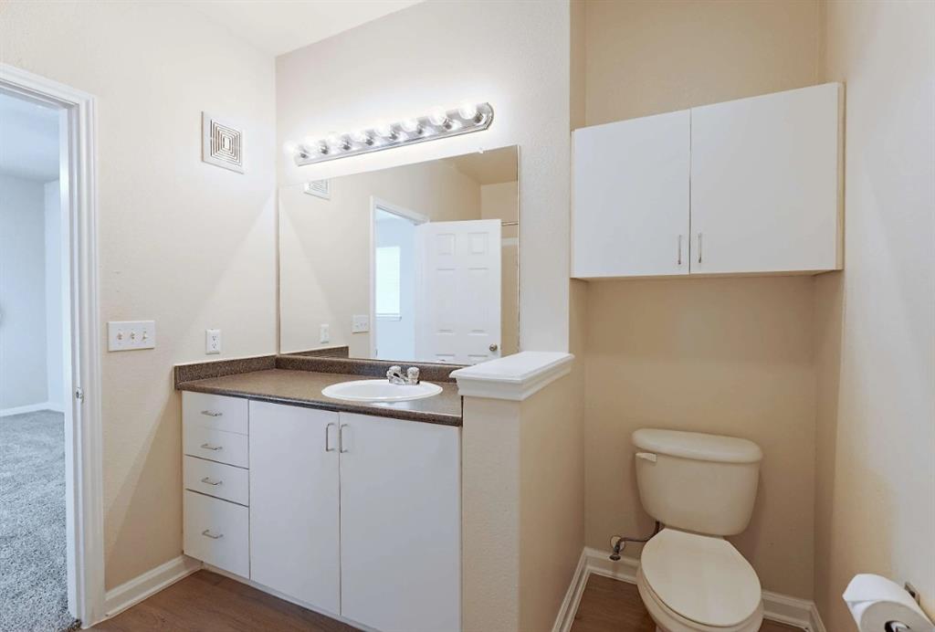 10505 I-35 Frontage Road South, Unit 632 Austin, TX 78747 - Photo 15 of 22 a bathroom with a toilet sink and mirror
