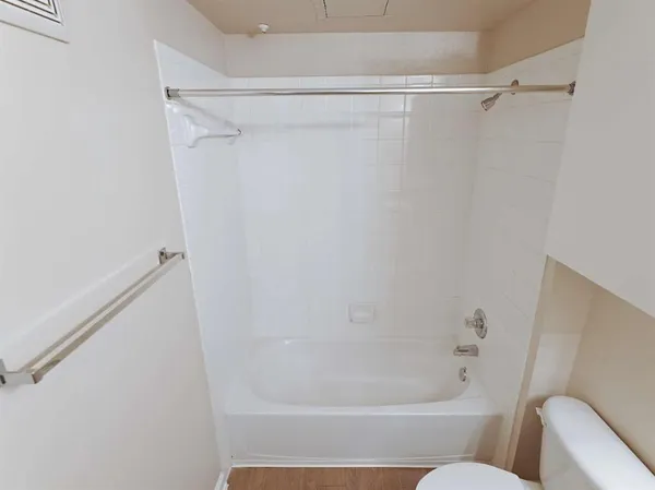 a bathroom with a shower and a bath tub