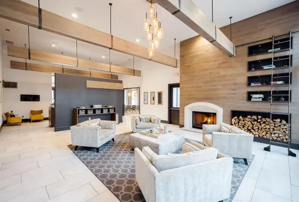 a living room with furniture and fireplace