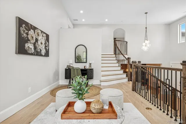 a dining room with furniture potted plants and wooden floor