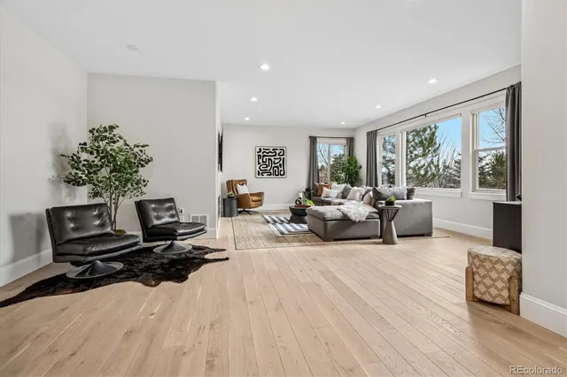 a living room with furniture window and wooden floor
