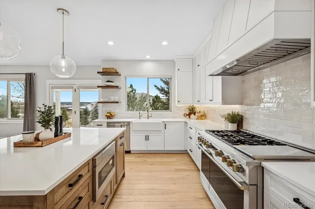 a kitchen with stove and white cabinets
