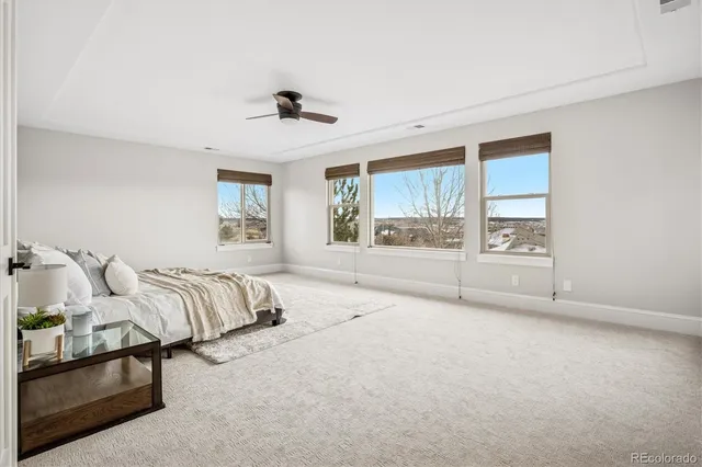a spacious bedroom with a bed and wooden floor