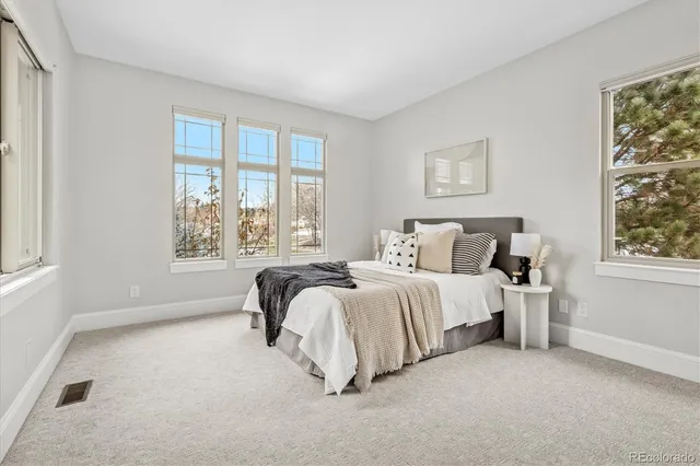 a spacious bedroom with a bed and a window