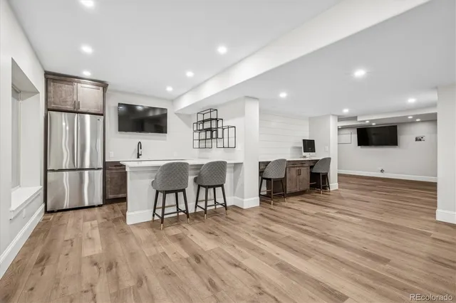 a view of a kitchen with furniture and wooden floor