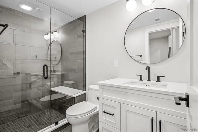a bathroom with a sink toilet and a mirror