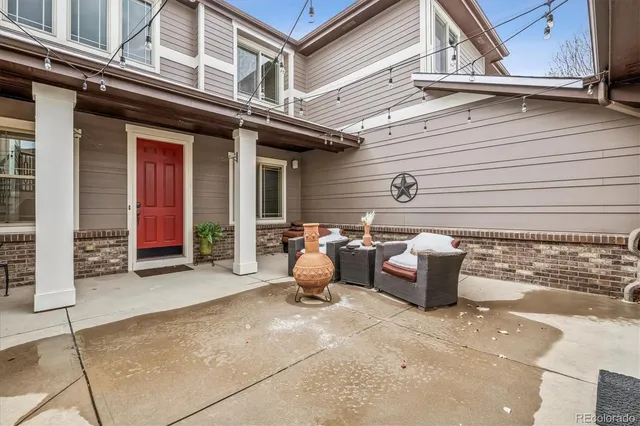 a view of a patio with couple of chairs and a fire pit