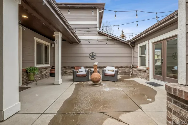 a view of a patio with table and chairs and potted plants