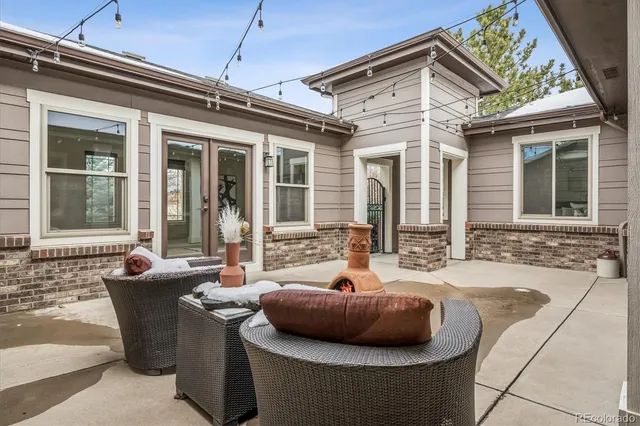 a view of a house with backyard and sitting area