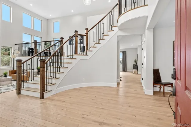 a view of entryway and hall with wooden floor