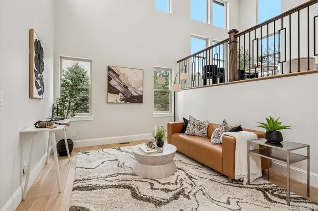 a living room with furniture and painting on the wall