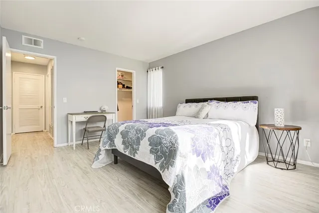 a bedroom with a bed and a table