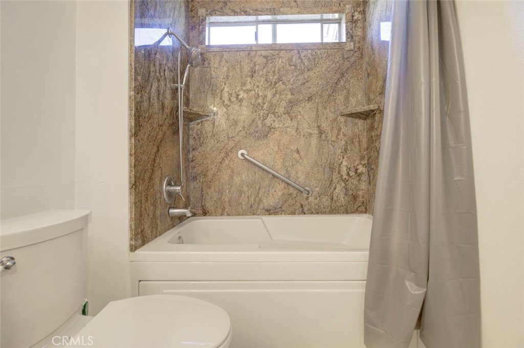 27620 Susan Beth Way, Unit L Saugus, CA 91350 - Photo 19 of 26 a bathroom with a toilet and a bathtub