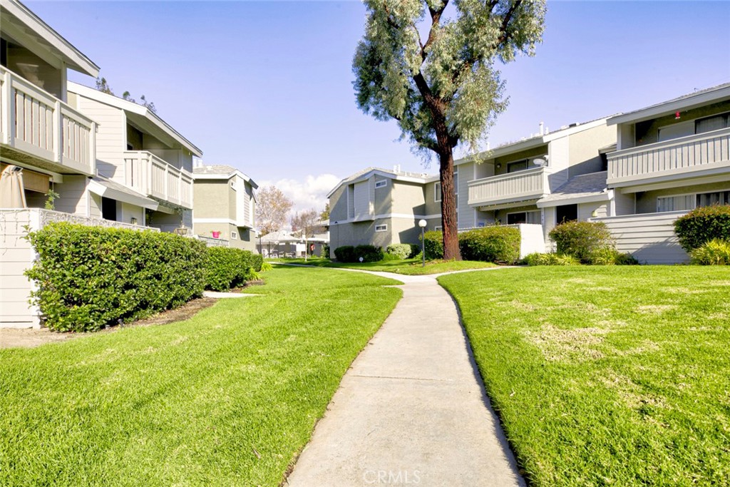27620 Susan Beth Way, Unit L Saugus, CA 91350 - Photo 24 of 26 a front view of a building with a yard