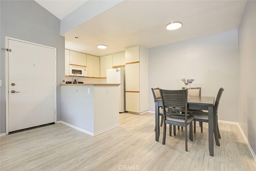 27620 Susan Beth Way, Unit L Saugus, CA 91350 - Photo 3 of 26 a view of a dining room with furniture and wooden floor