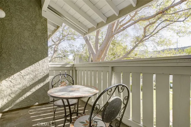 a view of a balcony furniture and dining area