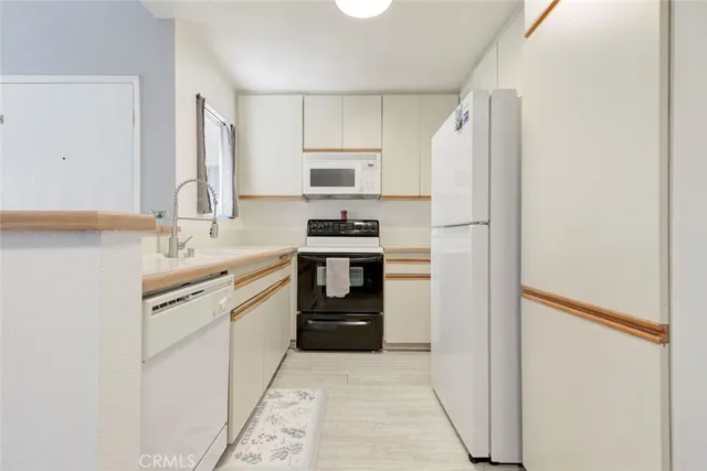 a kitchen with a sink appliances and cabinets
