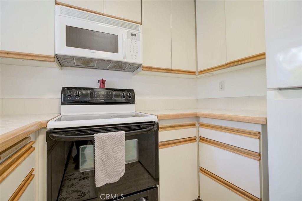 27620 Susan Beth Way, Unit L Saugus, CA 91350 - Photo 10 of 26 a kitchen with a stove and a microwave
