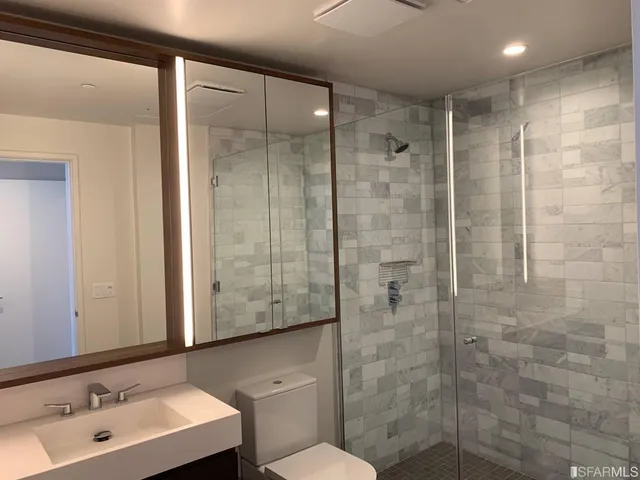a bathroom with a shower sink and mirror
