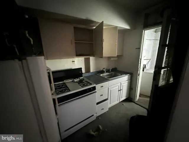 a kitchen with a stove and white cabinets