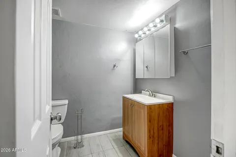 a bathroom with a sink vanity and a mirror