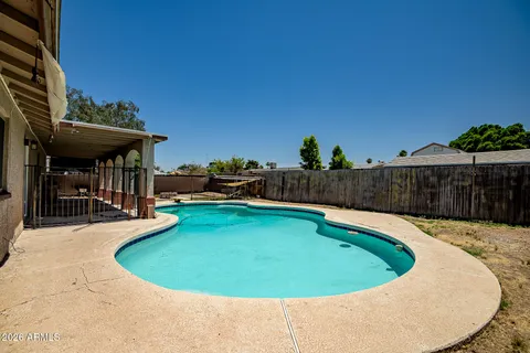 a view of a swimming pool with a patio