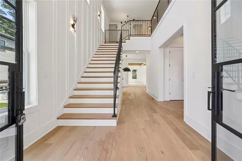 a view of a hallway with wooden floor and entryway