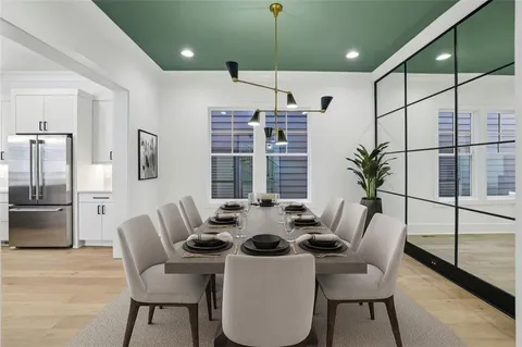 a kitchen with a table chairs stove and refrigerator