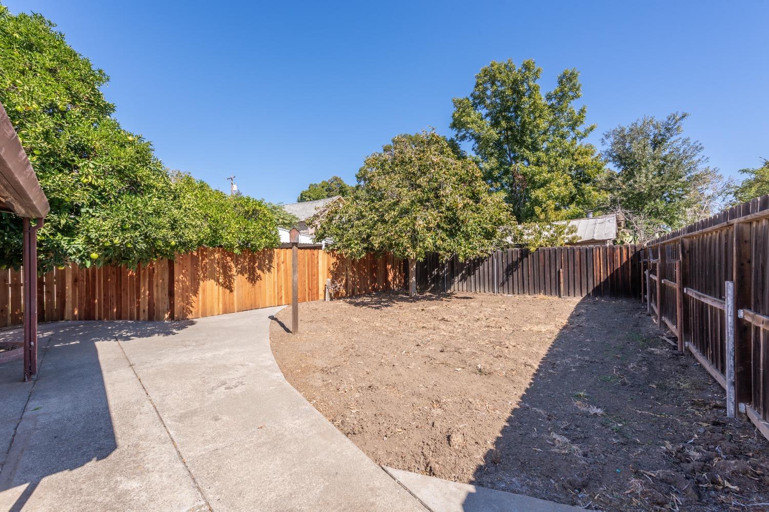 24 East Abbey Street Winters, CA 95694 - Photo 33 of 36 Just East of the workshop, large separate area from the main home that has alley access. Another possibility is to take down the newer fence and expand the backyard.