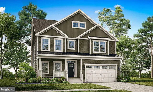 a front view of a house with a yard and potted plants