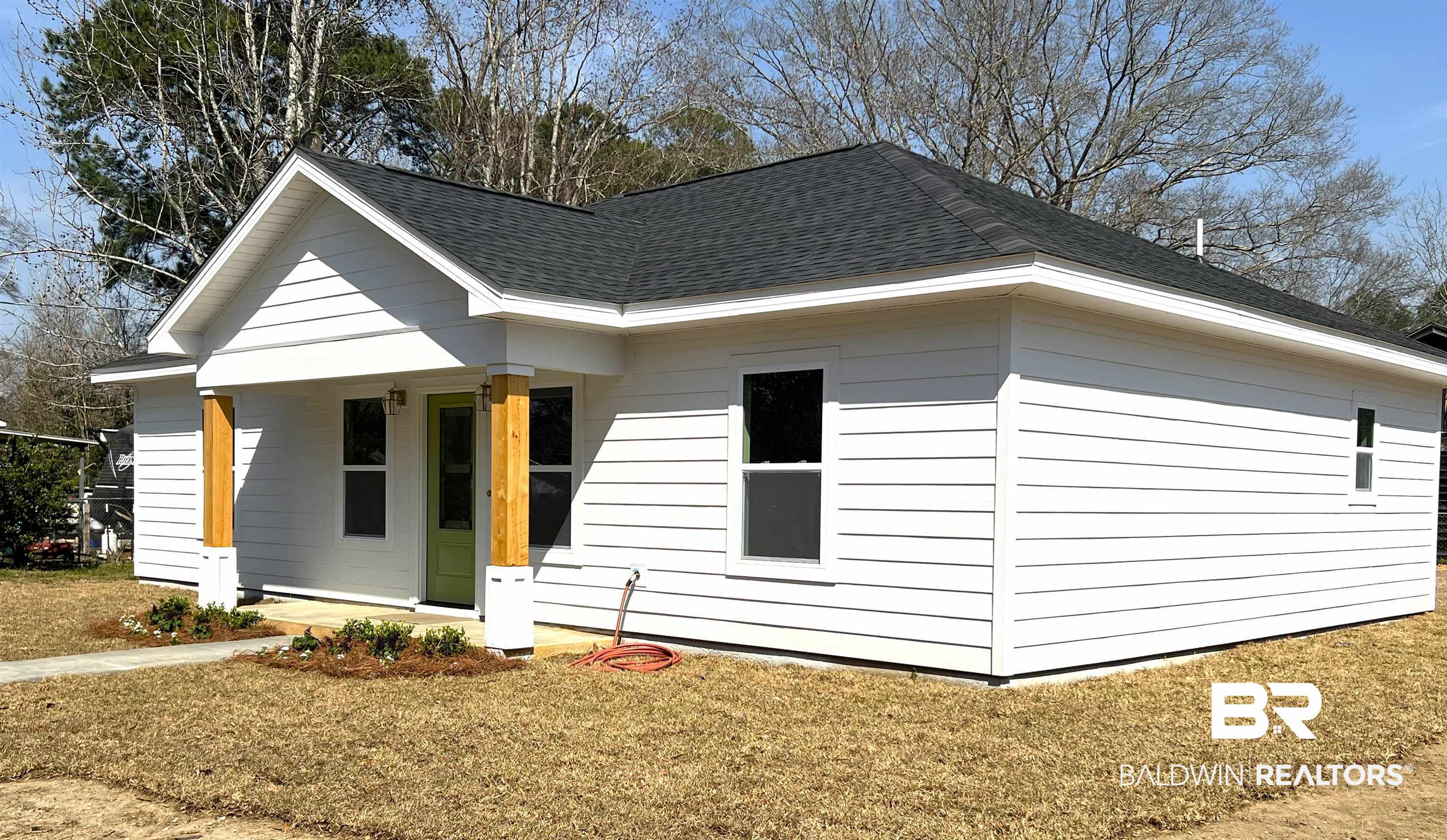 102 Earl Street Brewton, AL 36426 - Photo 18 of 27 Exterior space featuring a shingled roof and a front lawn