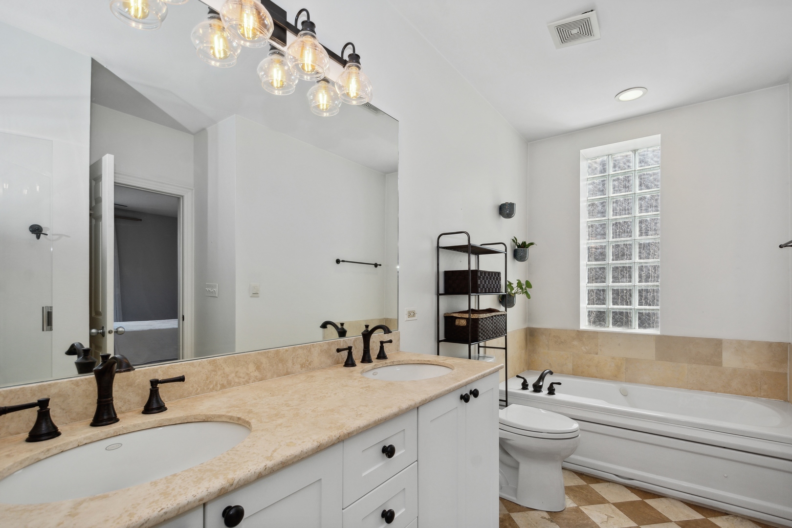 2147 West Rice Street, Unit 2E Chicago, IL 60622 - Photo 11 of 16 a bathroom with a granite countertop sink mirror vanity bathtub and a toilet