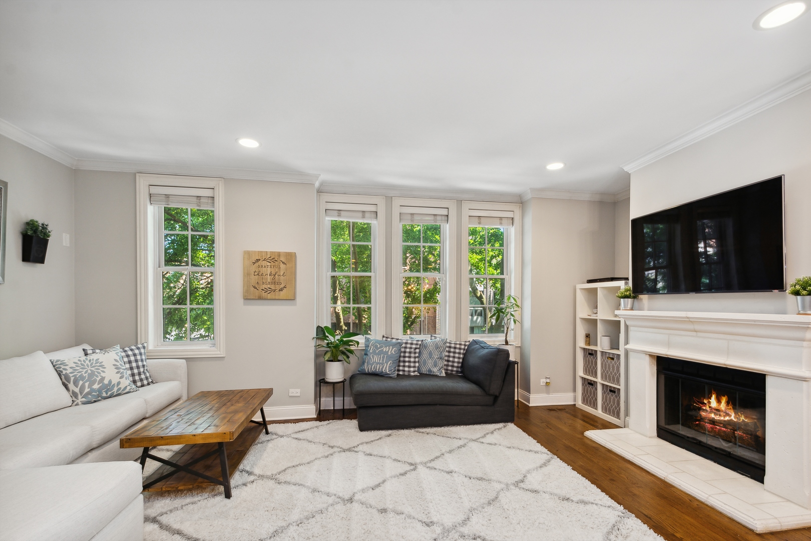 2147 West Rice Street, Unit 2E Chicago, IL 60622 - Photo 3 of 16 a living room with furniture a fireplace and a flat screen tv