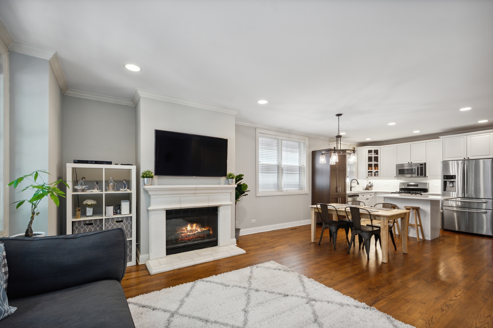 2147 West Rice Street, Unit 2E Chicago, IL 60622 - Photo 4 of 16 a living room with furniture a flat screen tv and a fireplace