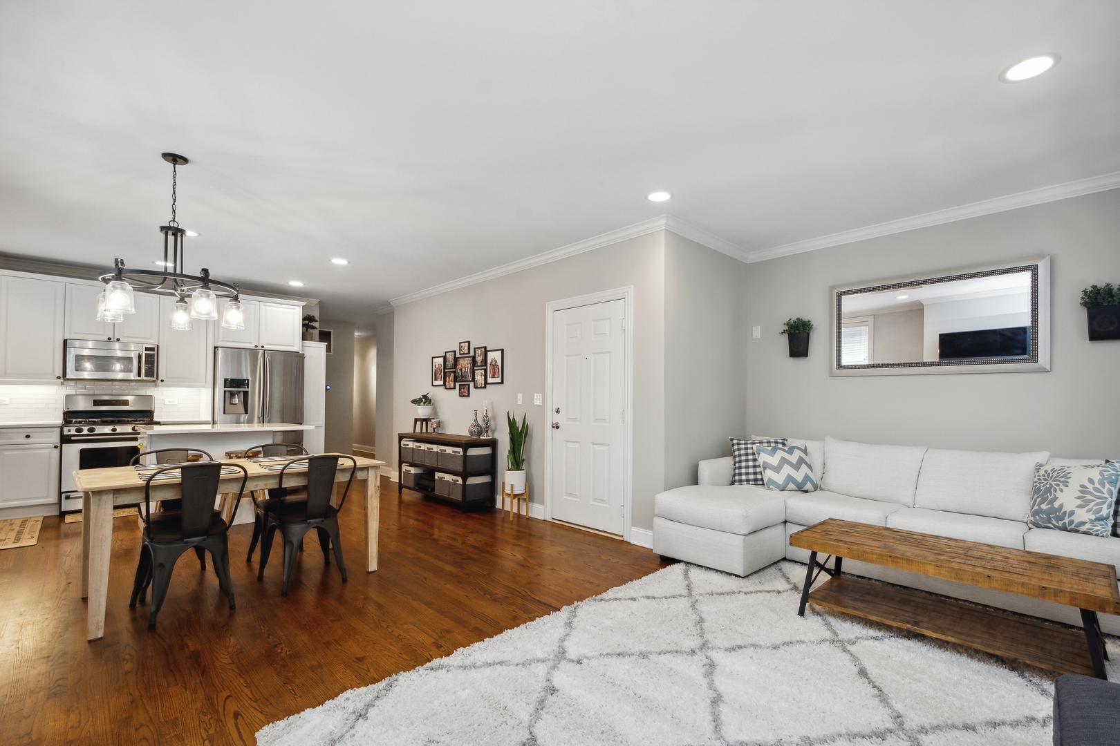 2147 West Rice Street, Unit 2E Chicago, IL 60622 - Photo 5 of 16 a living room with lots of furniture and kitchen view