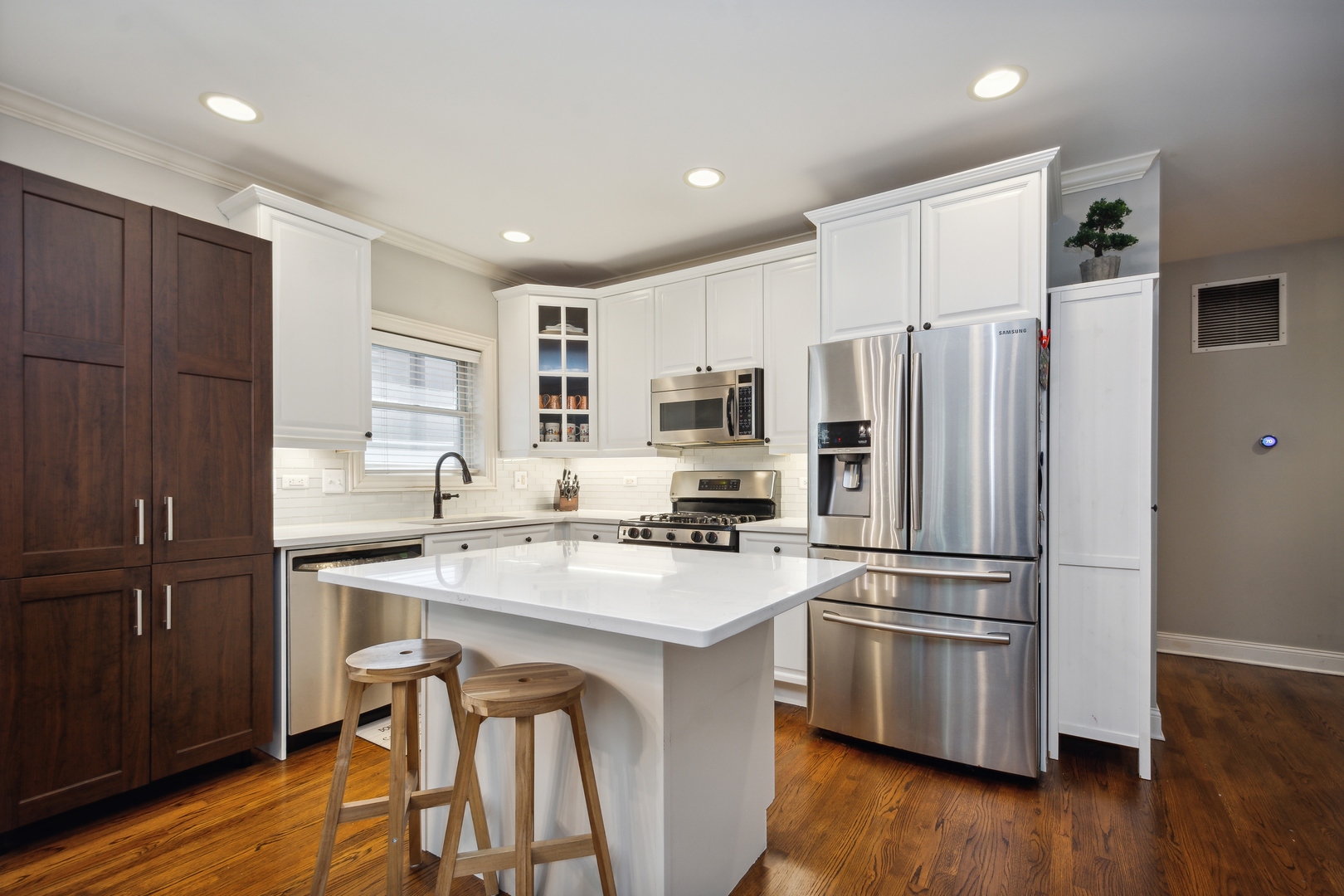 2147 West Rice Street, Unit 2E Chicago, IL 60622 - Photo 6 of 16 a kitchen with wooden cabinets and stainless steel appliances